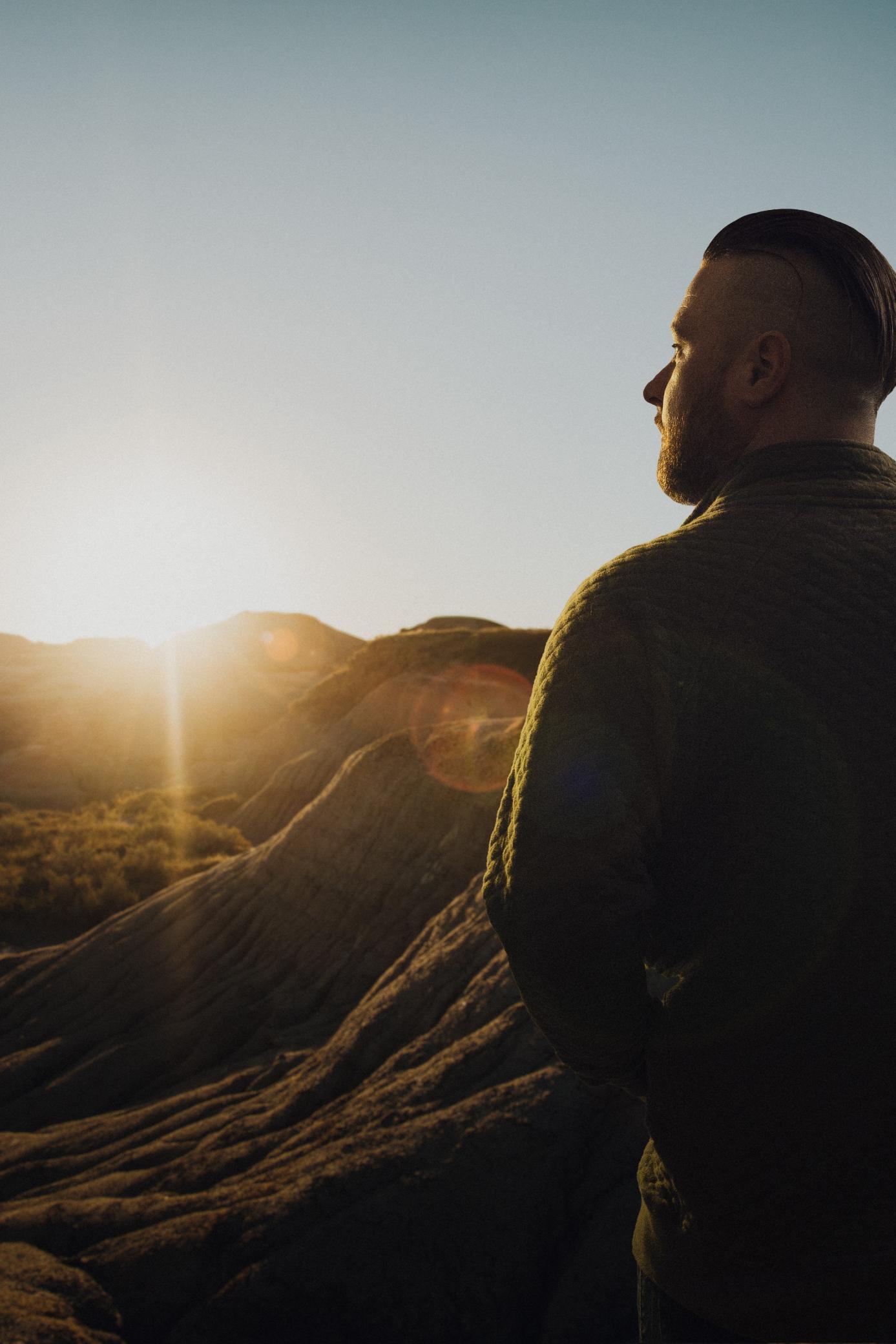 man looking at sunrise